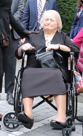 Aimee Stephens outside the US Supreme Court in October 2019, in a wheelchair, smiling.